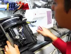 Vacuum repair technician servicing internal components on a workbench in Henderson, NV
